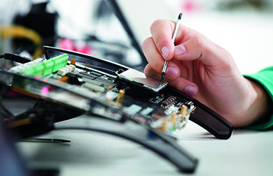 Close up of hand using a circuit console with a stylus