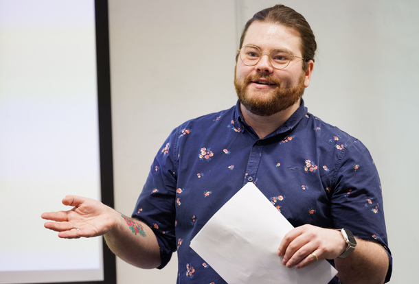 Business student holding a piece of paper 