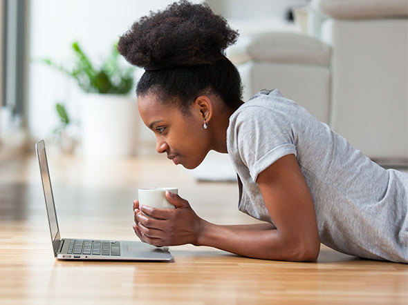 Women looking at laptop on floor