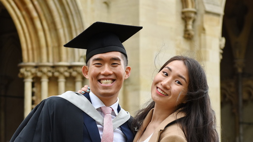 Image of a male student and family member on graduation day