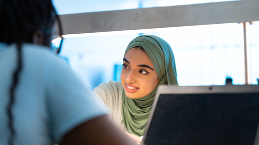 Student wearing hijab, in conversation