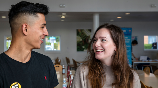 Two young people talking and smiling