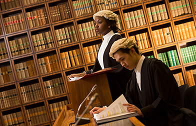Two students wearing wigs in the mock law court