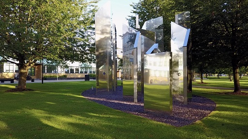 Several columns that are reflecting the sun on campus
